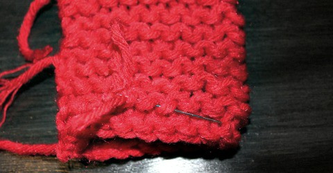 Pulling the ends through on the simple to knit fingerless gloves.